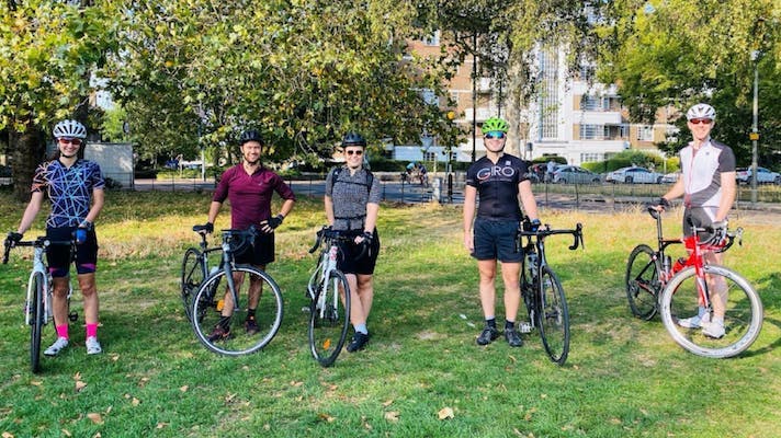 Five Alfa employees in Clapham Park with their bicycles