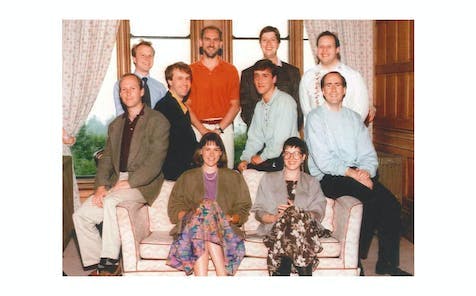Founding members of CHP Consulting sitting on a sofa in 1990