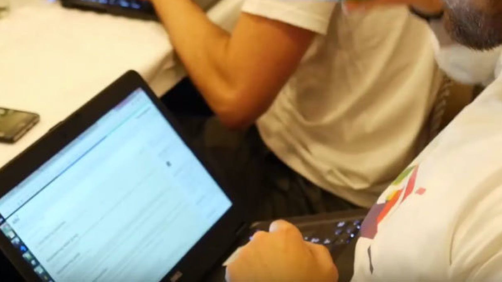 Close up of an Alfa employee on a laptop at a Hackathon